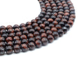 Perles Oeil de Taureau 10mm sur fil 38cm